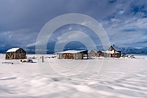 ABANDONED FARM IN SNOWING WINTER WEATHER