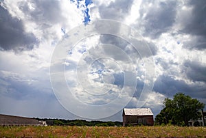 Abandoned farm with storm clouds
