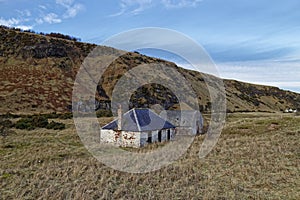 An abandoned Fishermen\'s Cottage and Ice house set back from the beach at St Cyrus