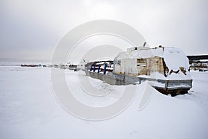 Abandoned fishing boats in the frozen river