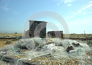 Abandoned Fishing huts and nets on beach.