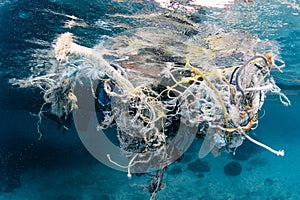 Abandoned fishing net and plastic garbage in the sea