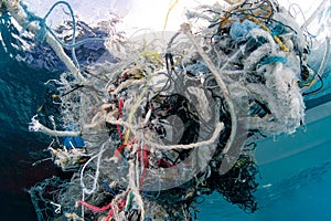 Abandoned fishing net and plastic garbage in the sea