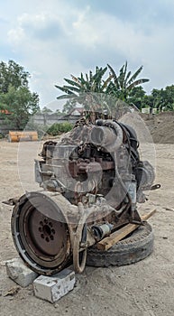 An abandoned four-cylinder diesel engine in the open