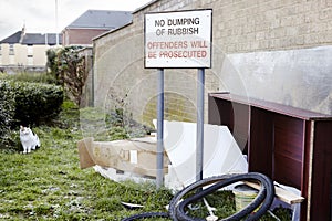 Abandoned garbage left next to no dumping sign photo