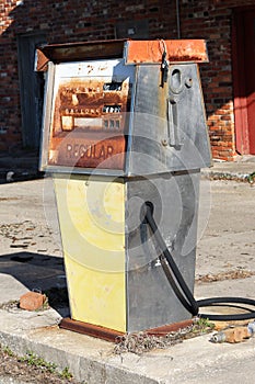 Abandoned gas pump in front of a gas station