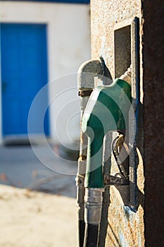 Abandoned gas station in the middle of nowhere. Old gas pump nozzle.