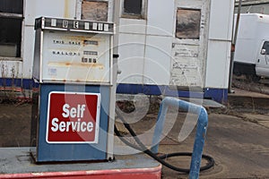 Abandoned gas station with old rusty pumps