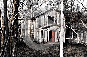 Abandoned ghost house with red door