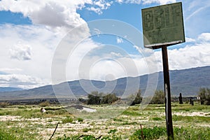 Abandoned golf driving range course in Borrego Springs, California. Only a rusty sign remains