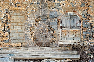 Abandoned grunge building with boarded up windows.