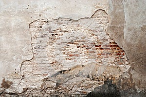 Abandoned grunge cracked brick stucco wall