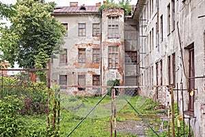 Abandoned grunge red brick building with boarded up windows