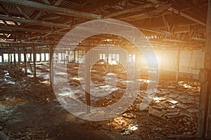 Abandoned, haunted and ruined industrial warehouse or factory building inside, large hall with perspective