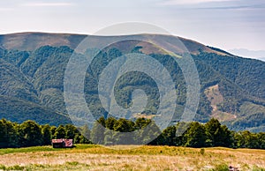 Abandoned herdsman shed on hillside near forest