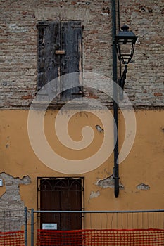 Abandoned house with brick facades and closed windows, Italy photo