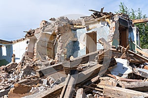 An abandoned house collapses. The house is destroyed. Cracks in wall of house. Destruction of old houses