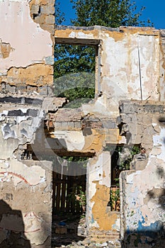 An abandoned house collapses. The house is destroyed. Cracks in wall of house. Destruction of old houses, earthquakes