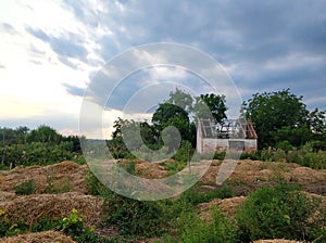 An abandoned house with a dismantled roof in a village