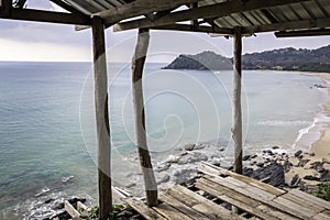 Abandoned house on the edge of the cliff overlooking the sea.