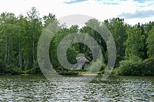 Abandoned house on the lake. Shooting from a boat.