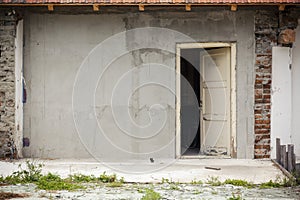 Abandoned house with open old door
