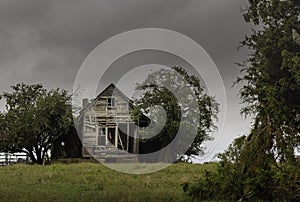 Abandoned house and overgrown trees on a remote backroads