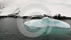 Abandoned house Water surface and desert snow coastline in ocean of Antarctica.