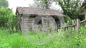 Abandoned hut and old wooden fence