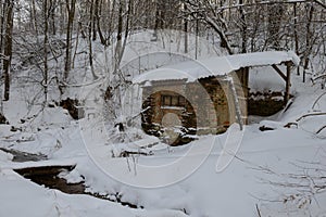 Abandoned hut in the snow-covered forest