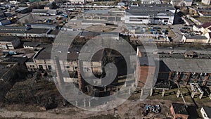 Abandoned industrial area. Old brick buildings and factory chimneys. Around a new residential city block. Aerial photography