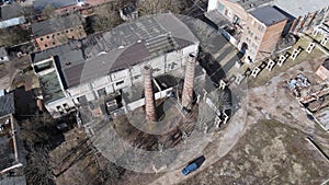 Abandoned industrial area. Old brick buildings and factory chimneys. Around a new residential city block. Aerial photography