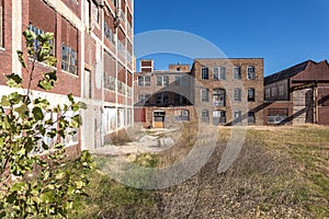 Abandoned industrial buildings with field and blue sky