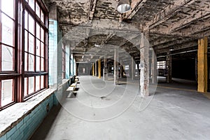 Abandoned industrial interior with hall and big windows