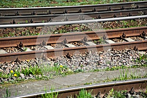 Abandoned industrial railroad tracks with corrosion