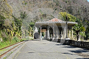 Abandoned inoperative railway. old railway station in abkhazia. tourist natural place with rails photo