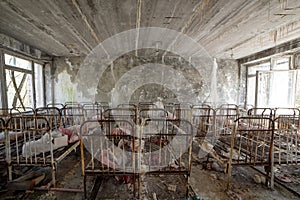 Abandoned kindergarten in Chernobyl Exclusion Zone. Lost toys, A broken doll. Atmosphere of fear and loneliness. Ukraine, ghost