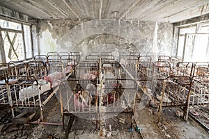 Abandoned kindergarten in Chernobyl Exclusion Zone. Lost toys, A broken doll. Atmosphere of fear and loneliness. Ukraine, ghost