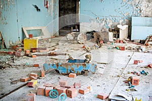 Abandoned kindergarten in Chernobyl Exclusion Zone. Lost toys, A broken doll. Atmosphere of fear and loneliness. Ukraine, ghost