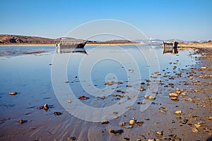 An abandoned Korean fishing boat washed ashore during a storm.