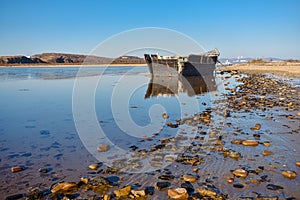 An abandoned Korean fishing boat washed ashore during a storm.