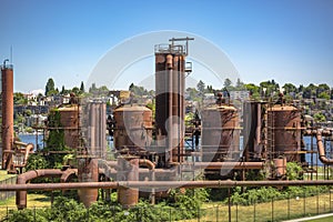 Abandoned machines and storage units in a gas industry at gas works park Seattle homes behind