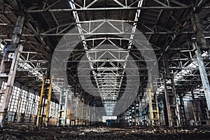 Abandoned metallurgical excavator plant or factory interior, industrial warehouse building waiting for a demolition