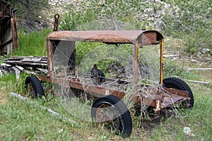 Abandoned mining vehicle cart in an overgrown field in Bayhorse Ghost Town in Idaho