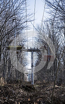 abandoned mountain Ski Lift in the forest with wood chairs