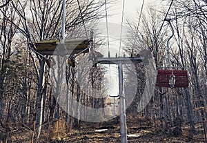 abandoned mountain Ski Lift in the forest with wood chairs