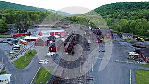 Abandoned Narrow Gauge Coal Rail Road with Rusting Hoppers and Freight Cars and Support Building