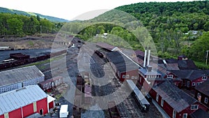 Abandoned Narrow Gauge Coal Rail Road with Rusting Hoppers and Freight Cars and Support Building