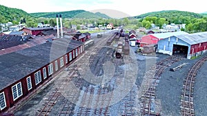 Abandoned Narrow Gauge Coal Rail Road with Rusting Hoppers and Freight Cars and Support Building