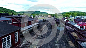 Abandoned Narrow Gauge Coal Rail Road with Rusting Hoppers and Freight Cars and Support Building